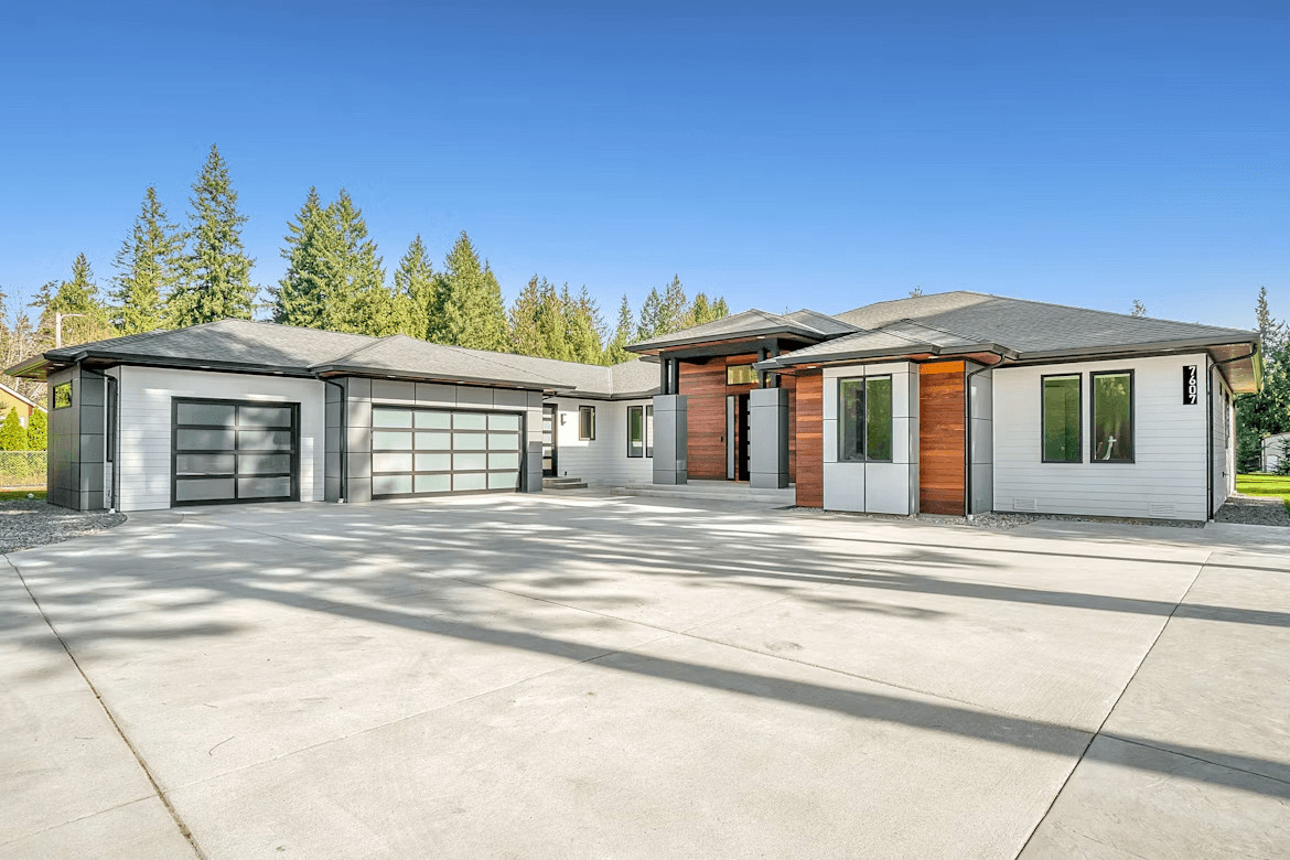 House with a large driveway and garage
