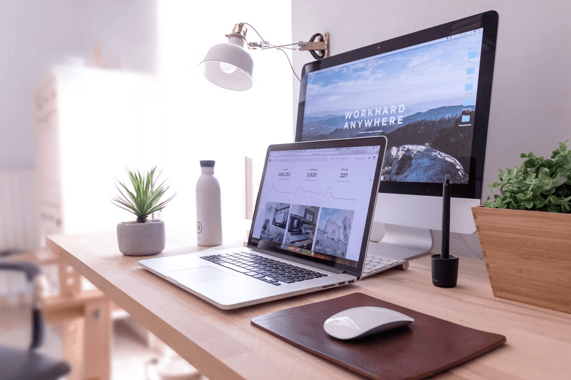 Laptop computer on a wooden desk, ready for remote