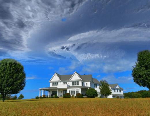 Large white house on a green field illustrating a