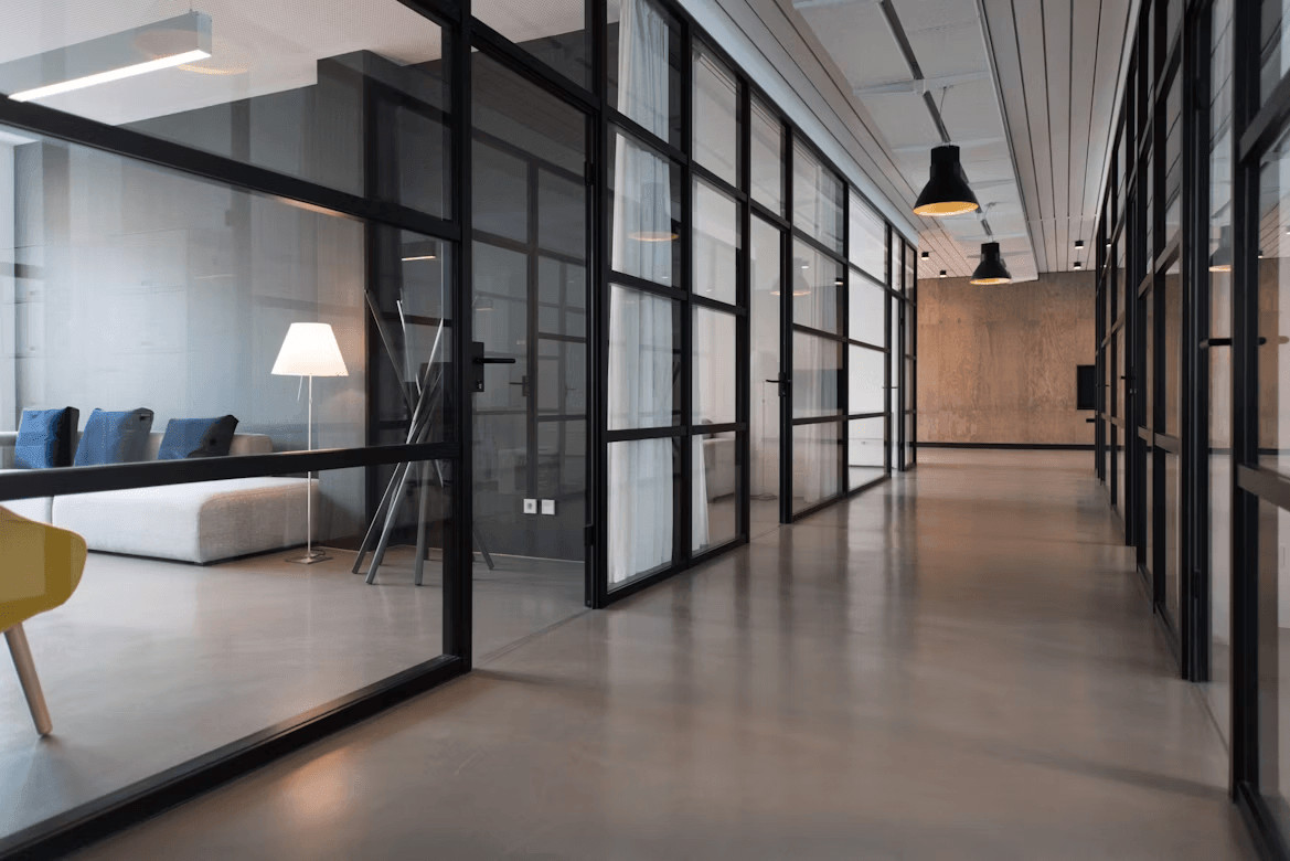 Long hallway featuring custom steel glass partitions and a yellow