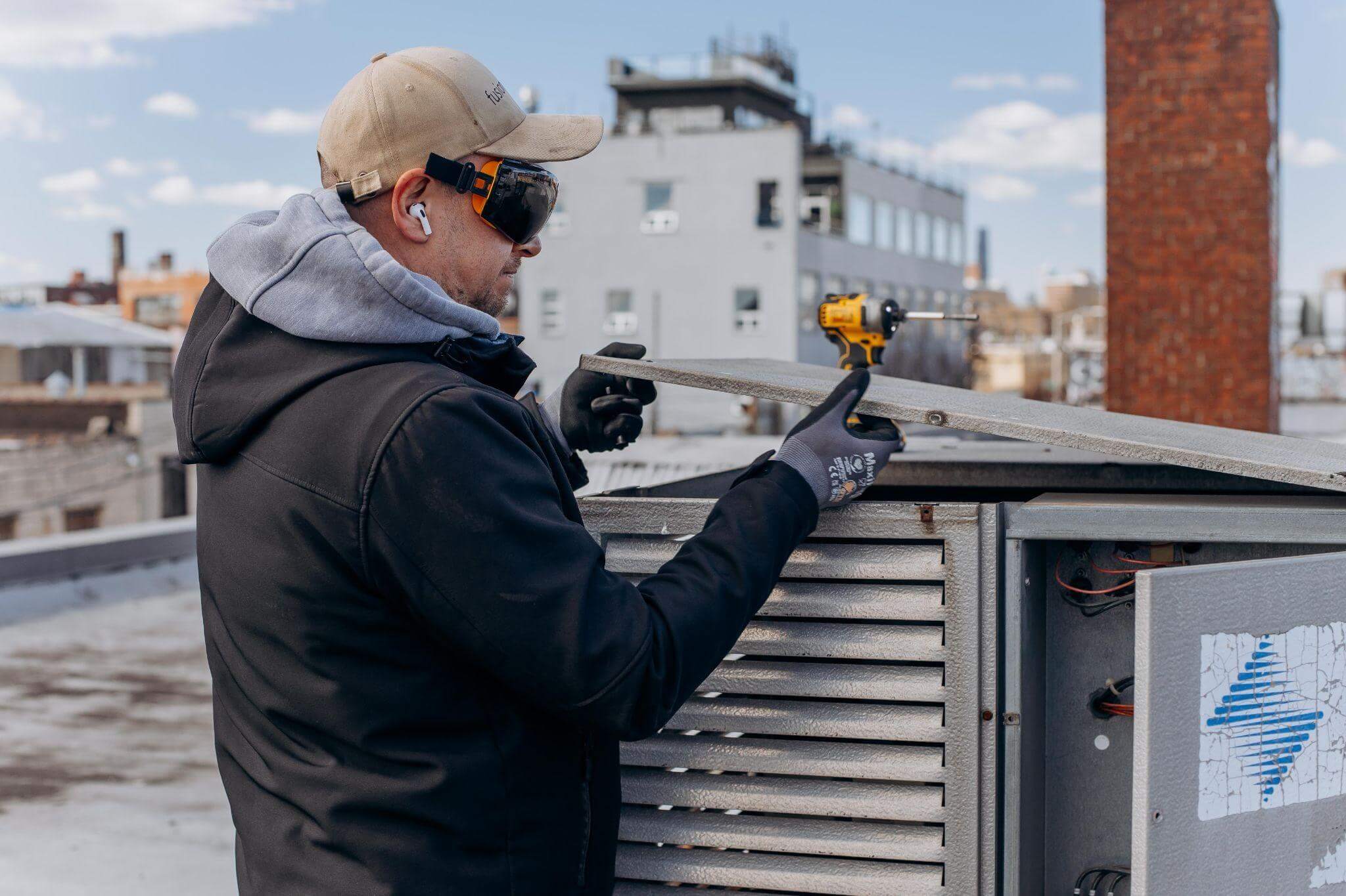 10 Things Homeowners and Business Owners Should Check Before Summer Hits 2 Man drilling on a roof for summer
