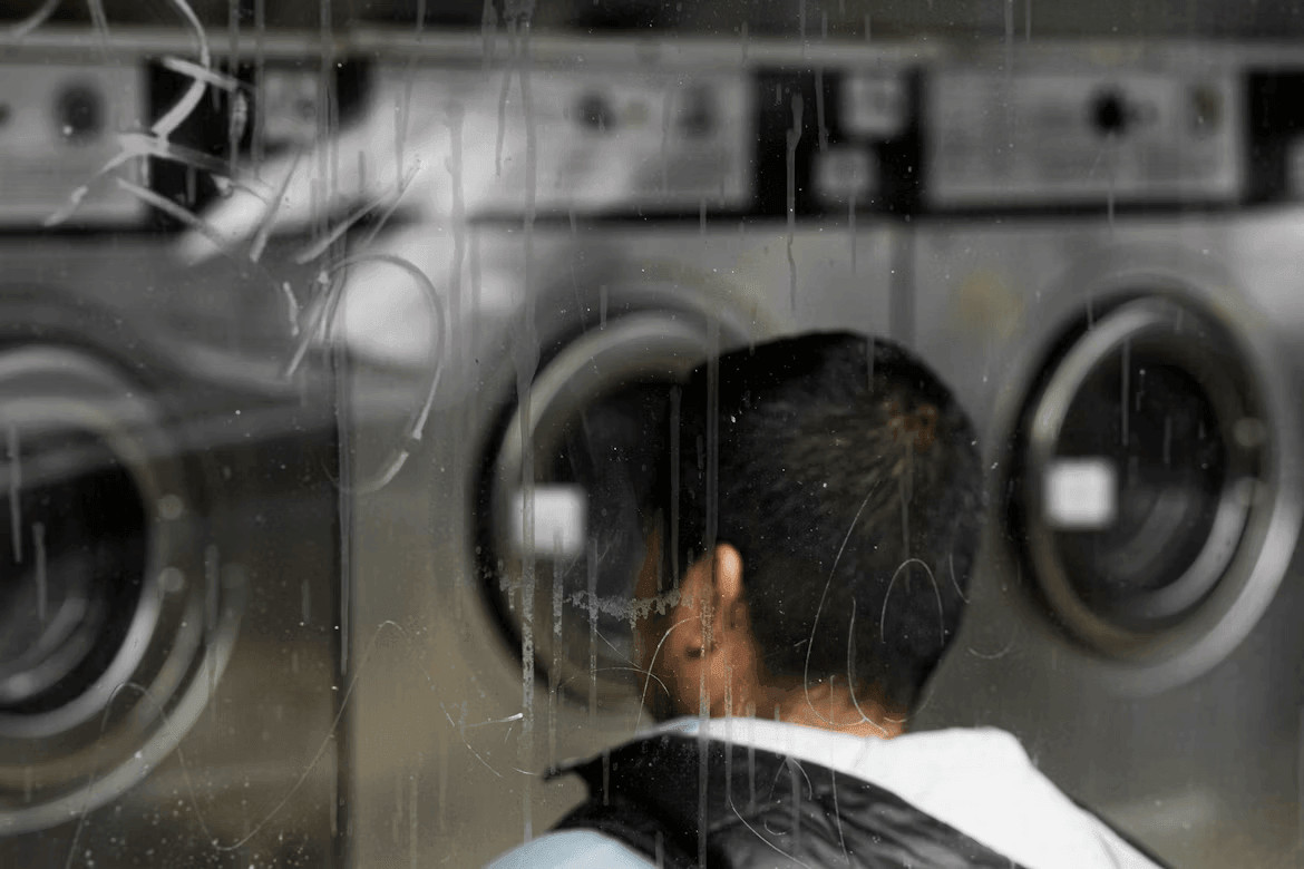 Repair or Replace? How to Decide When a Major Appliance Breaks Down 1 Man examining a row of washing machines
