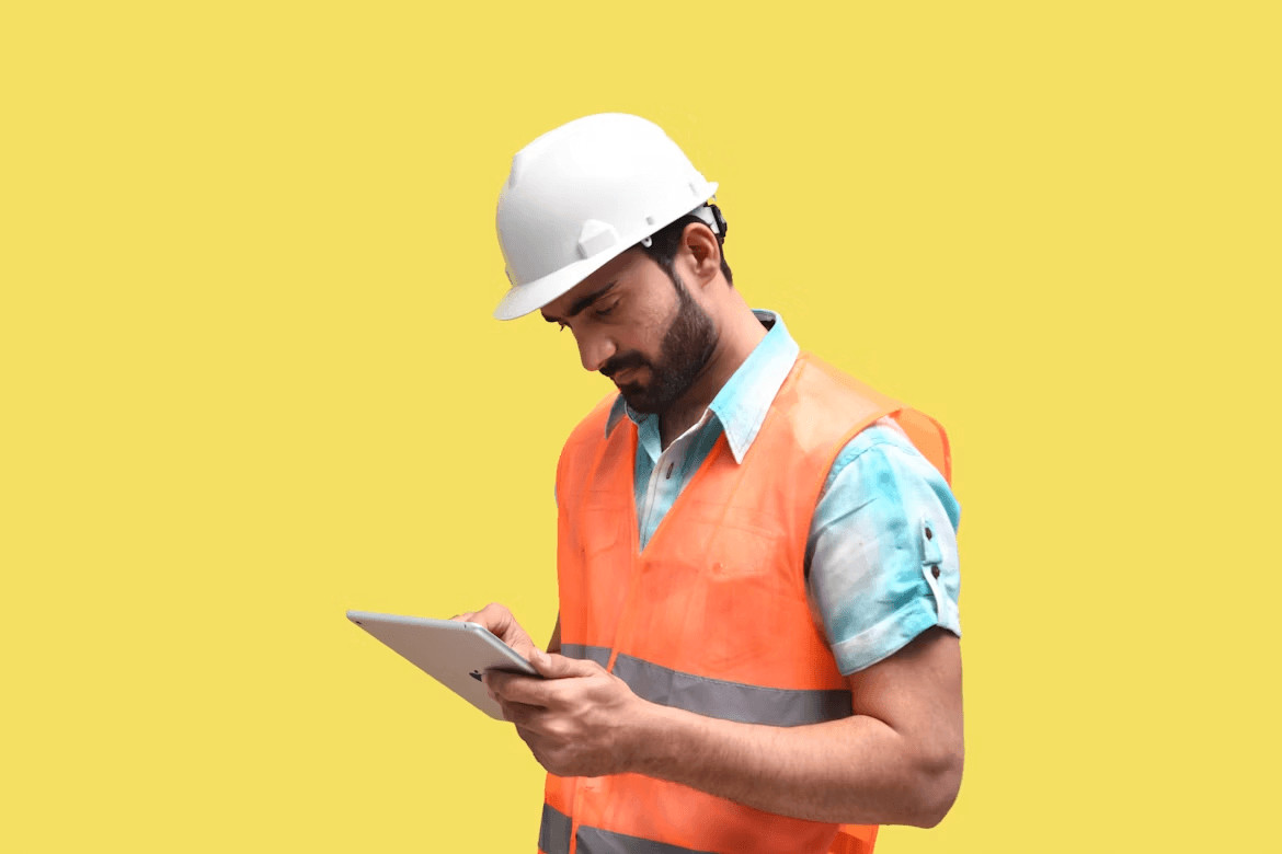 Man in an orange safety vest using