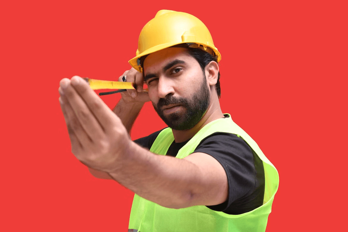 Man in yellow safety vest holding scissors