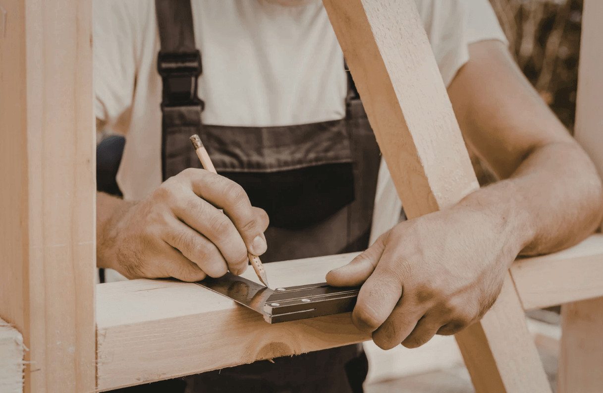 Man measuring wood for a DIY project