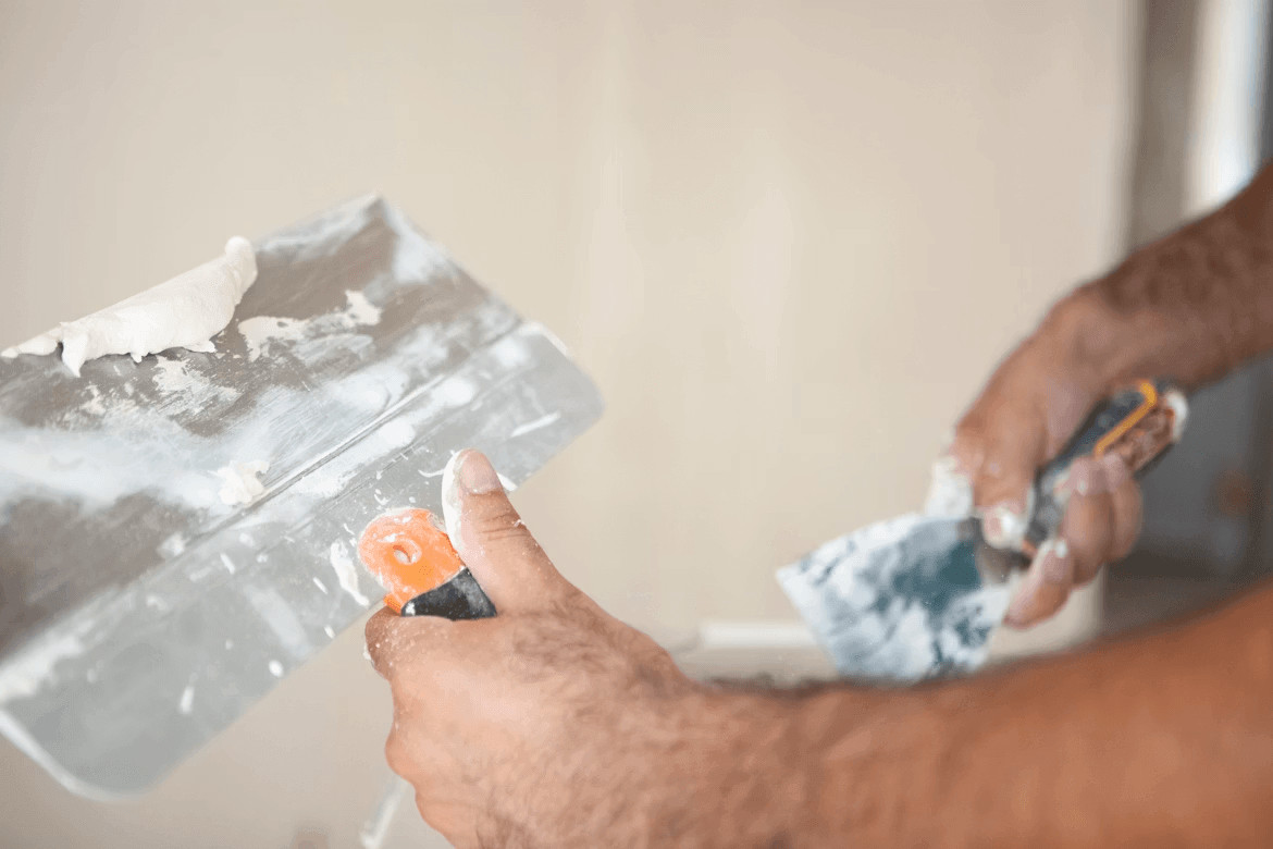 The Biggest Exterior Painting Mistakes Homeowners Make Before the First Coat 1 Man painting an exterior wall white