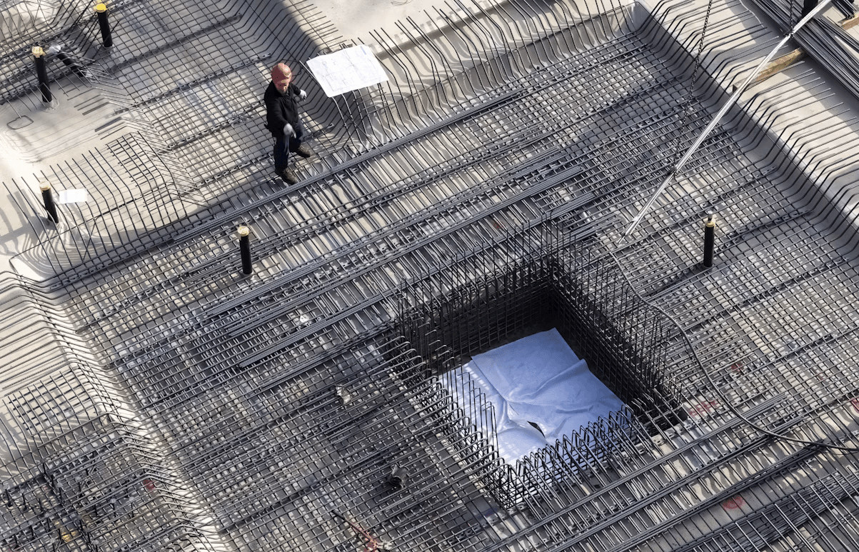 How Basement Waterproofing Helps Prevent Costly Foundation Repairs 1 People viewing a large metal structure,