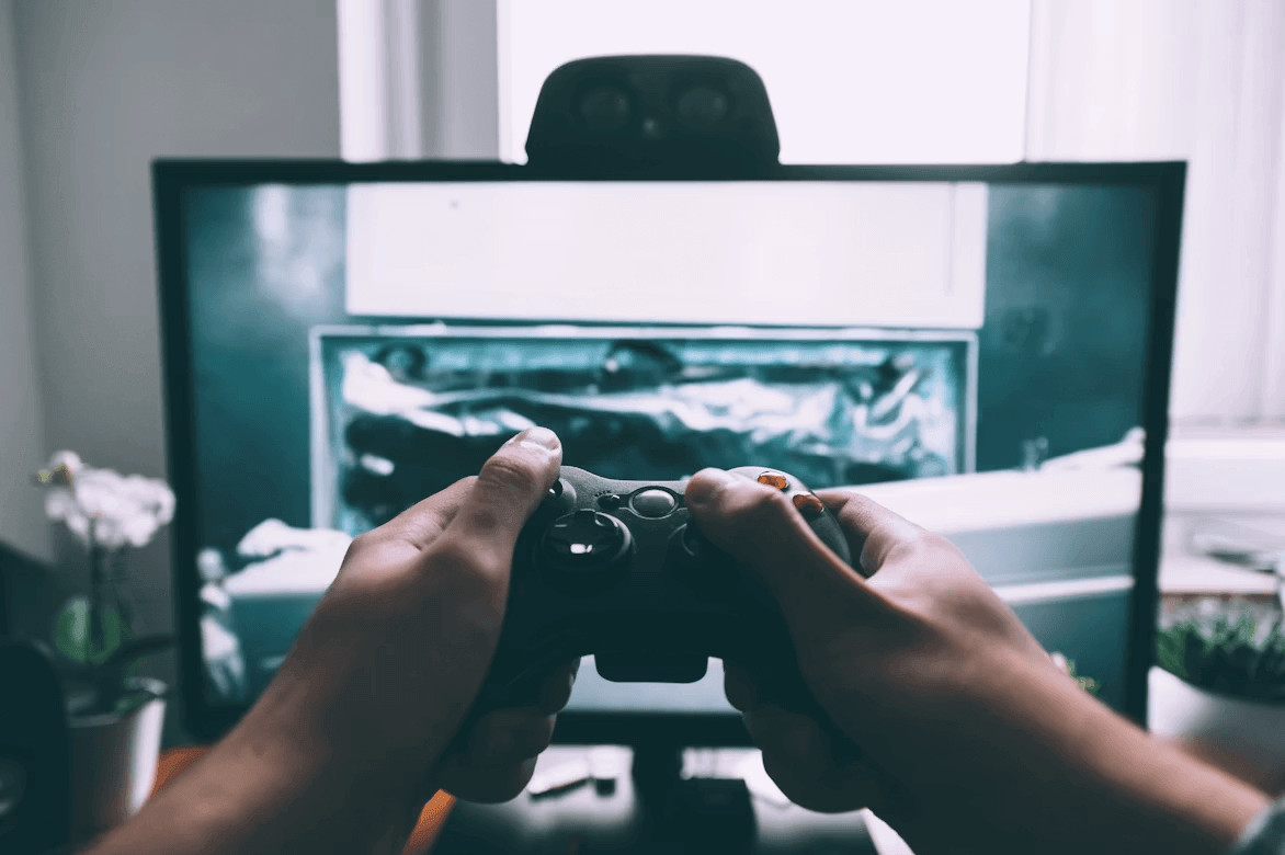 Person playing a video gamecontroller on an