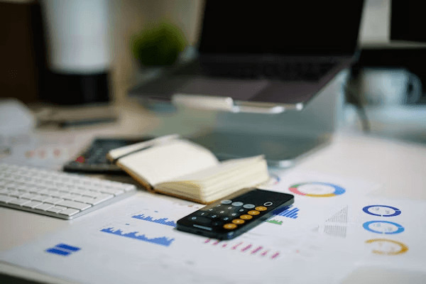 Remote control and book on a table, symbolizing smart