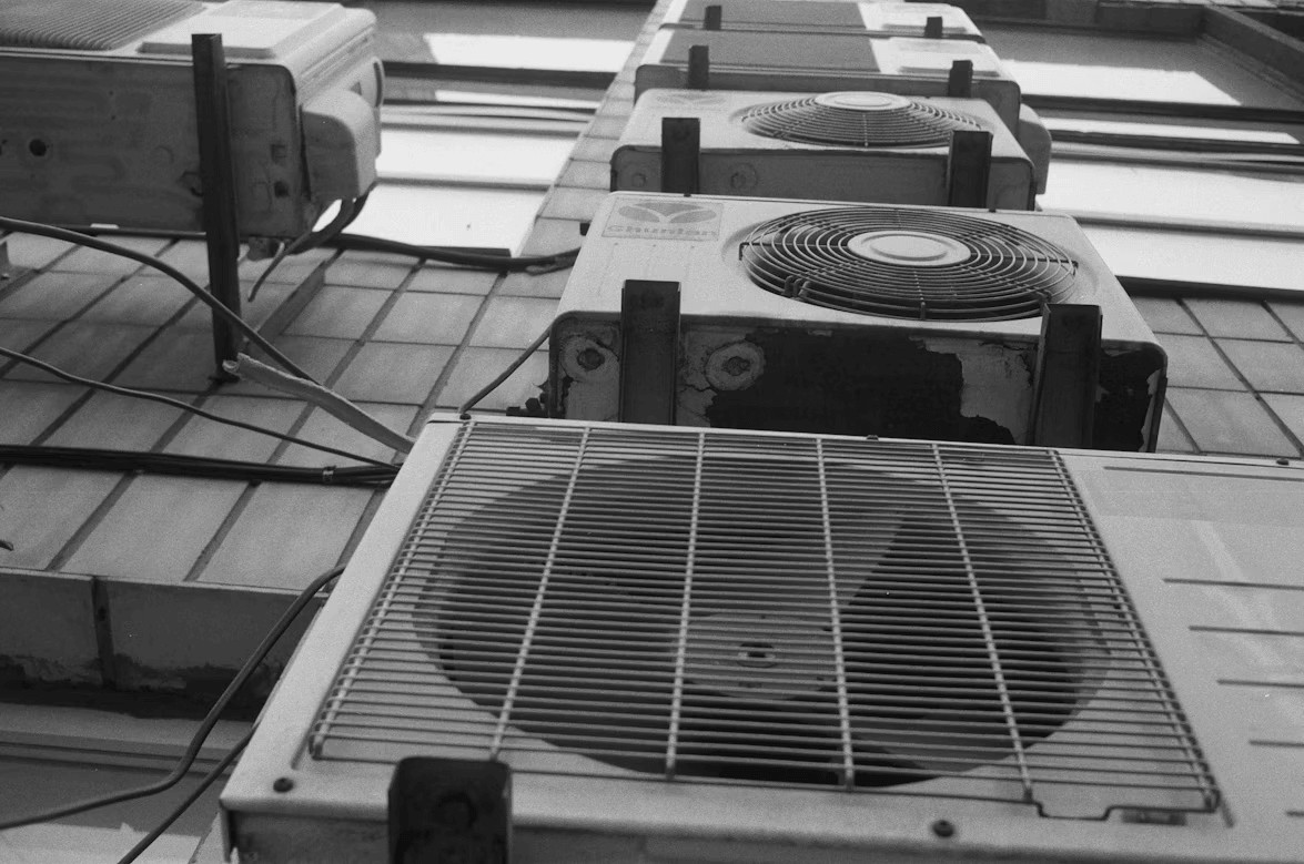 Row of old air conditioners on a tiled
