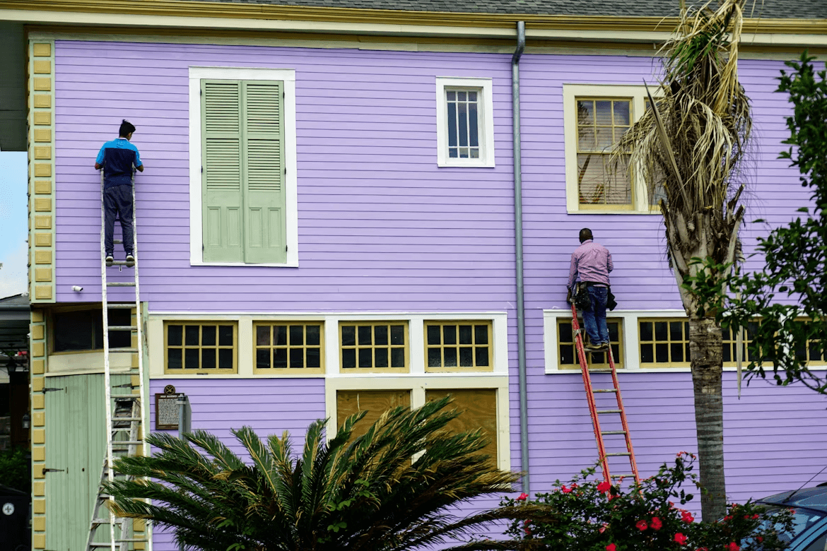 How to Prepare Your Home for a Long-Lasting Paint Job 1 Two men painting a purple house