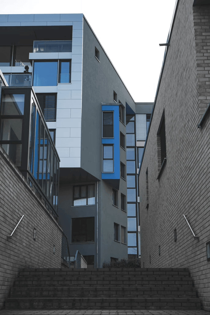 Two older apartment buildings side-by-side in