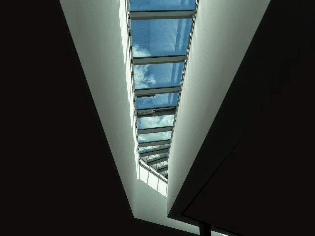 View of blue sky through a modern building window