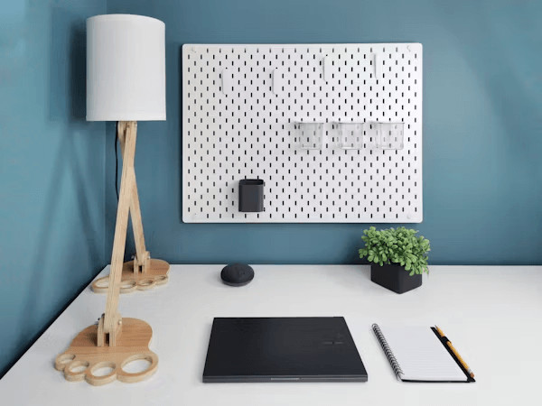 DIY Pegboard Systems for Organizing Learning Materials 1 White desk with a laptop, lamp, and space