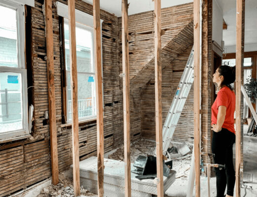 The Construction Payment Bottleneck Timeline: Why Projects Slow Down And How Homeowners Can Stay Ahead 2 Woman in a room under construction, illustrating