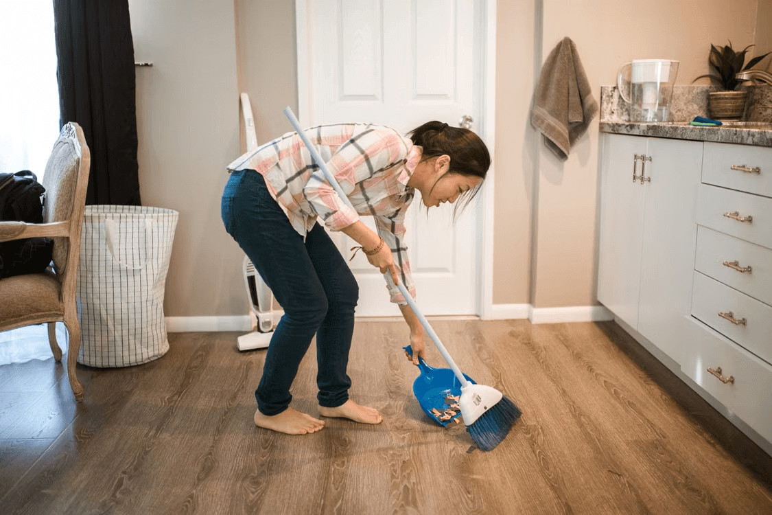 Woman mopping a newly installed hardwood floor
