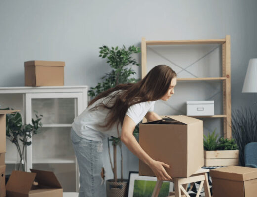 Tips and Tricks to Make Your Move Easier 21 Woman moving boxes in a living room during a move