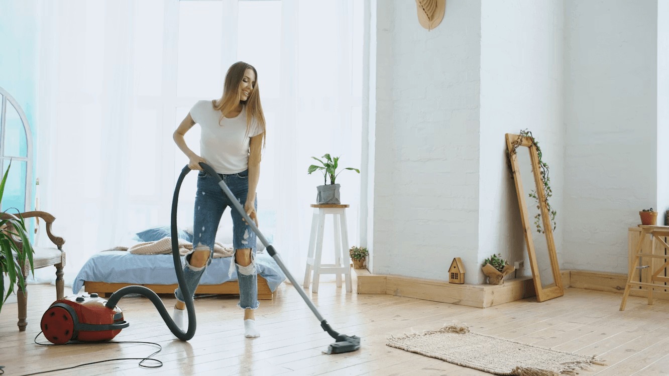 Why Regular Domestic Carpet Cleaning Is Essential for a Healthier Home 2 Woman vacuuming a bed for domestic cleanliness