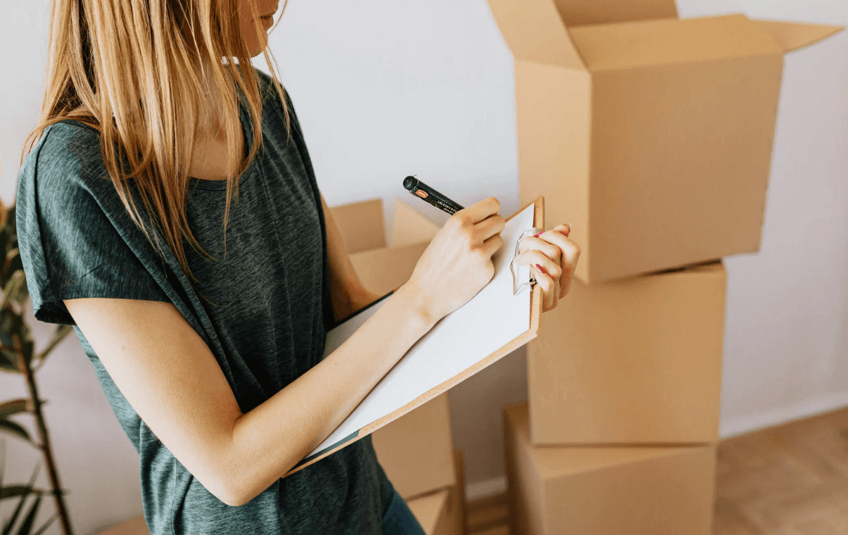 Hidden Moving Costs You Need to Budget For 1 Woman writing down hidden moving costs