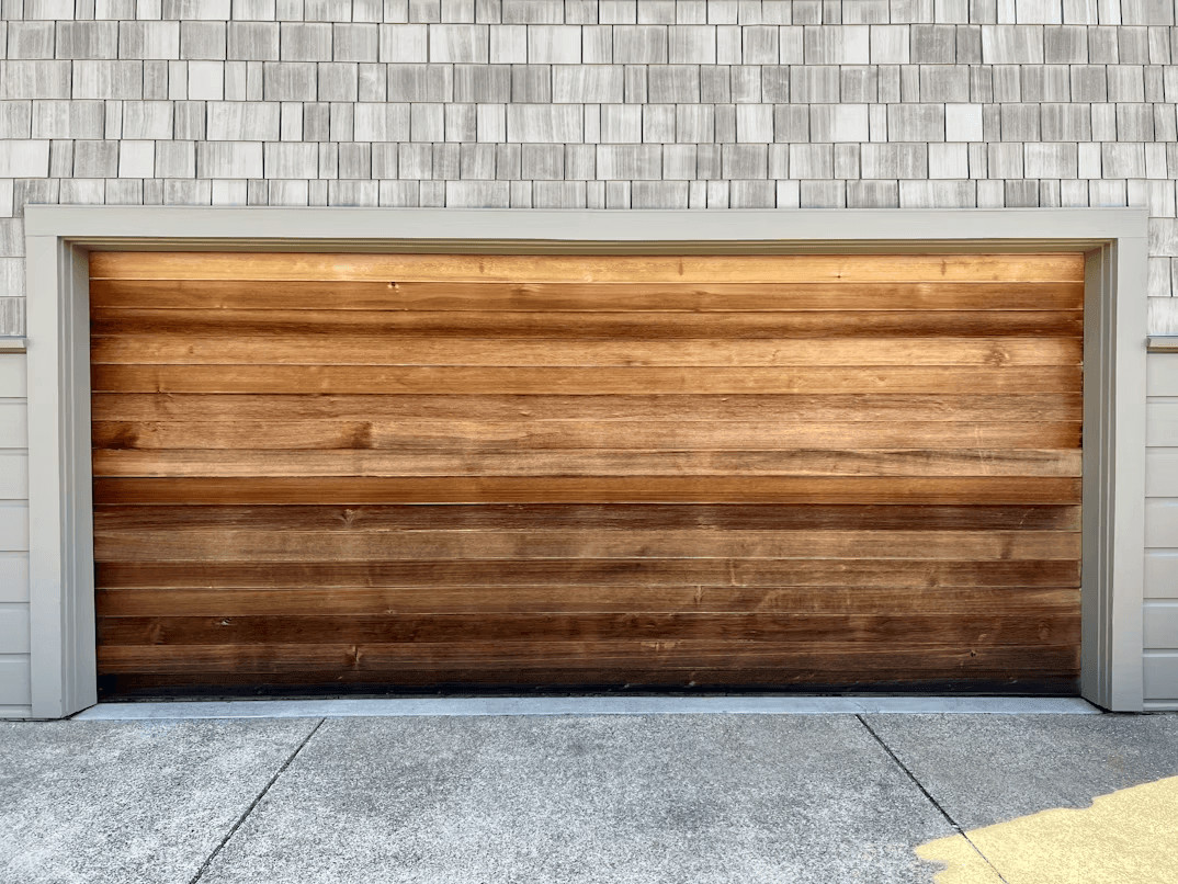 Wooden garage door on a brick home