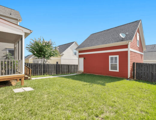 A backyard with a fence and a