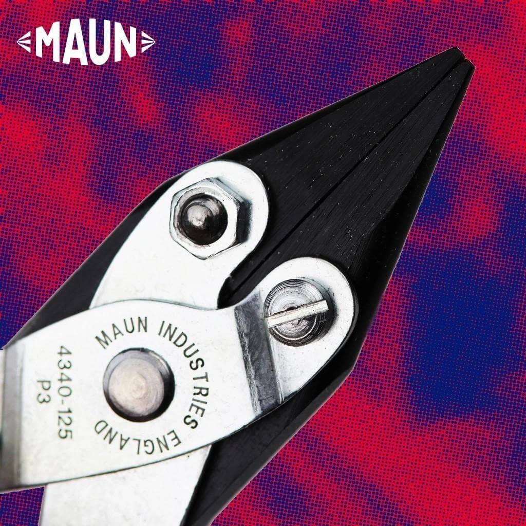 A pair of parallel pliers on a purple and red