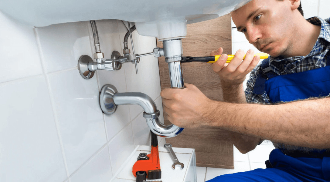 Home Improvement Projects That Call for a Professional Plumber 2 A pro pumbler fixing a bathroom sink