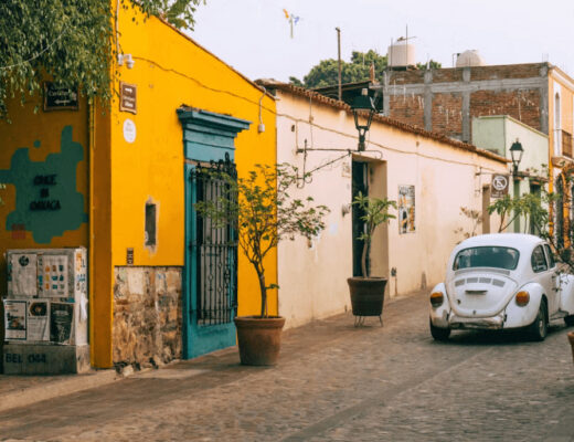 A white car parked in front of a yellow