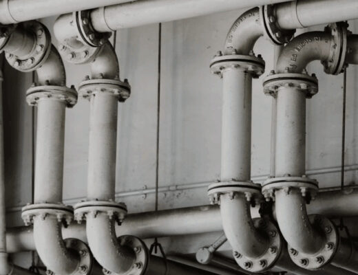 Black and white image of home plumbing pipes in
