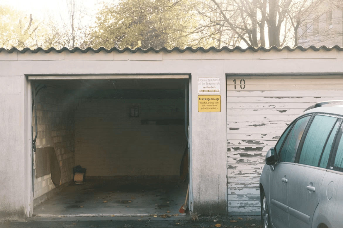 Car parked in front of a coastal home garage