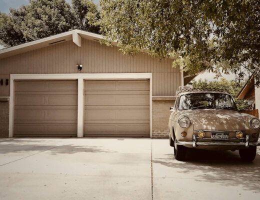 Car parked in front of a coastal home with