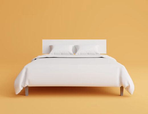 Comfortable bed with white sheets and pillows