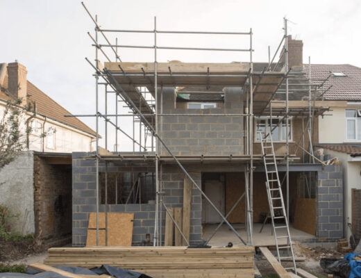 Custom home under construction with scaffolding and
