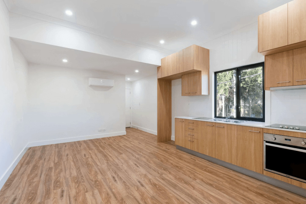 How Renters Can Get Their Property Ready for the Final Inspection 1 Empty kitchen with wood floors and white walls for final