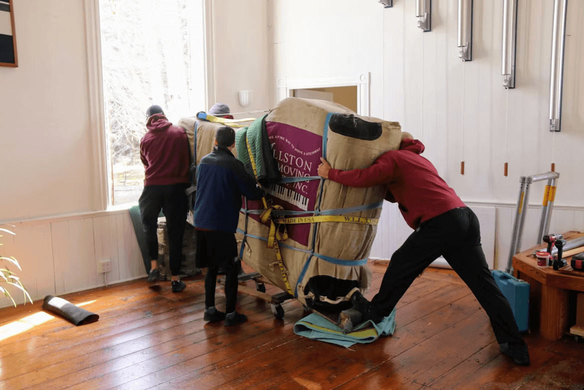 Group of people with a large moving bag