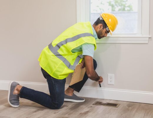 Man in hard hat inspecting a home