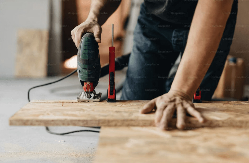 Man sanding wood during home repair