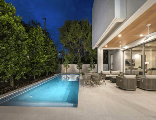 Modern vacation home with swimming pool at night