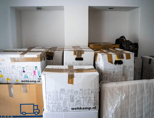 Stacked moving boxes in a room,