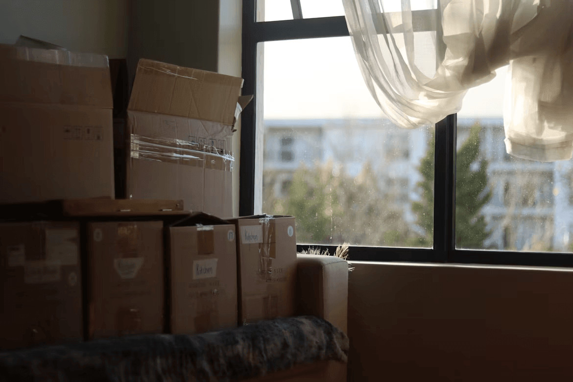 Stacked moving boxes on the floor in a new home