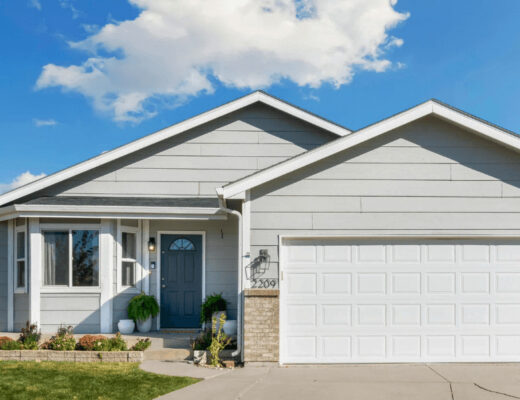 How Weather Affects Garage Door Performance 153 White house under clear blue sky with a visible
