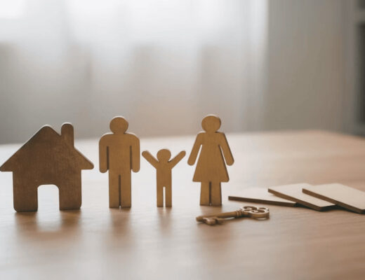 Wooden figures representing a family standing next to a