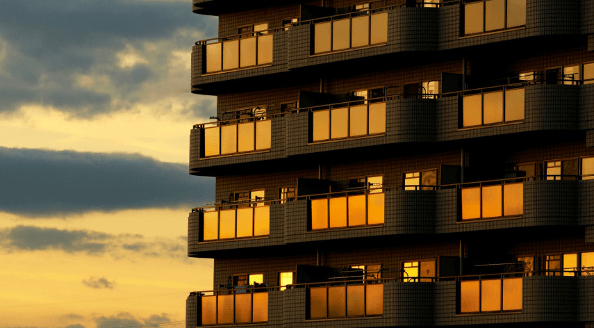 A Kansas City high-rise building with lit balconies