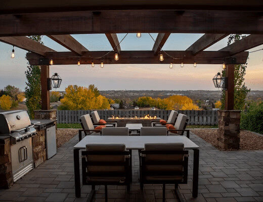 A patio with a table, chairs, grill,