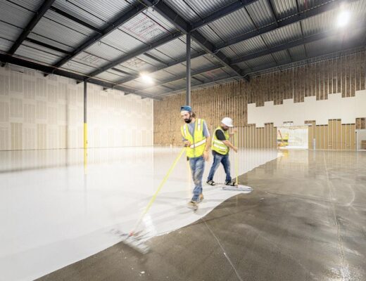 An industrial floor scrubber machine cleaning a warehouse floor