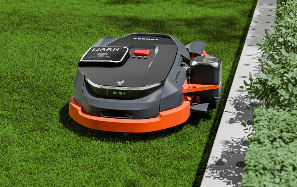Lawn mower on lush green field for yard maintenance