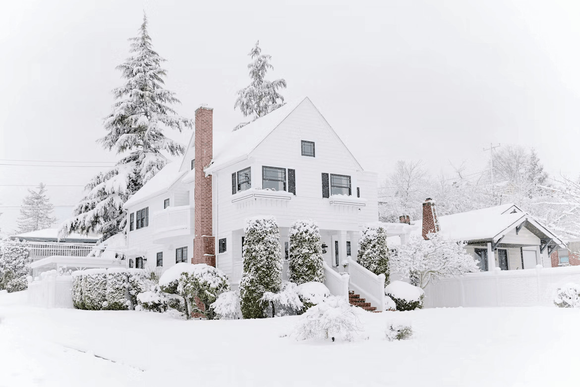 Snow-covered house in winter landscape