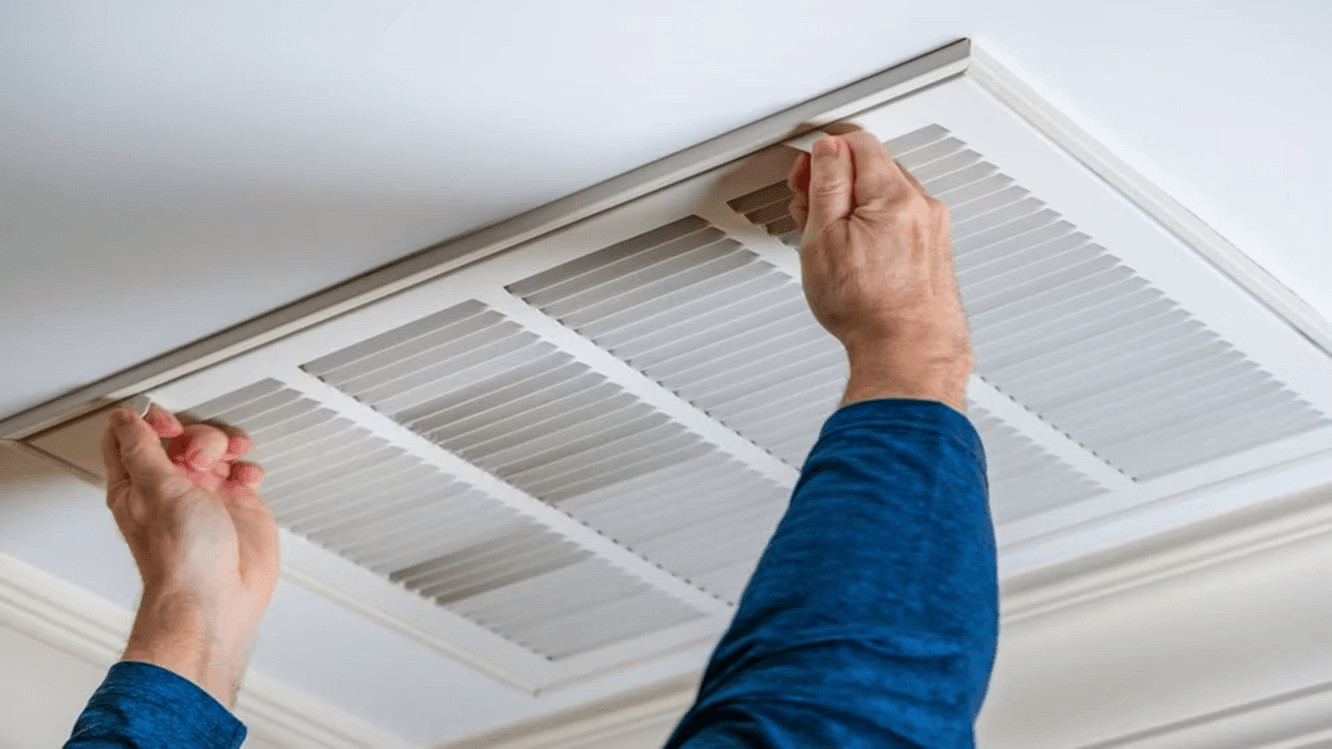 7 Best Air Duct Cleaning Companies in Maryland (2026) 1 Technician working on ceiling air conditioner for