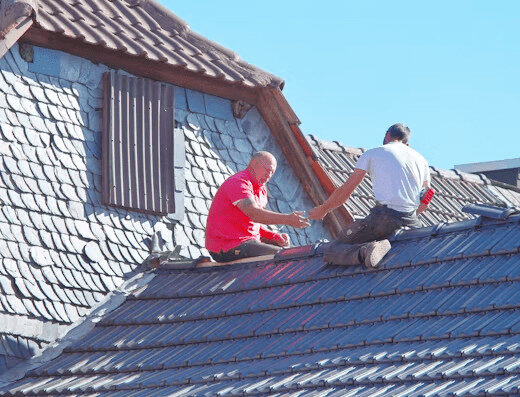 Two men performing roof maintenance on a Florida house.