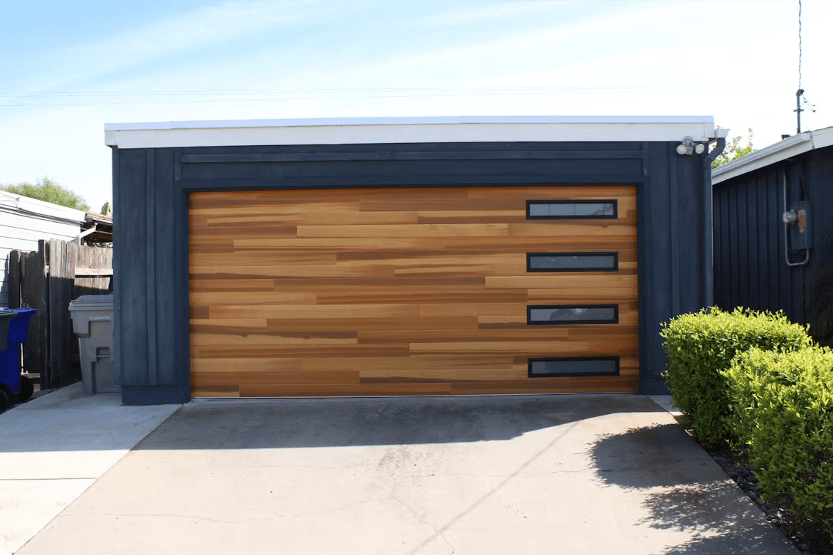 Garage Door Installation, Repairs, and Maintenance Every Homeowner Should Know 2 Wooden garage door on a house garage